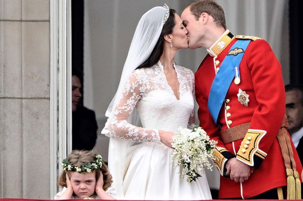 Britain's Prince William kisses his wife Kate, Duchess of Cambridge, on the balcony of Buckingham Palace